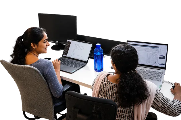 Two Ucartz team members working together at their desks